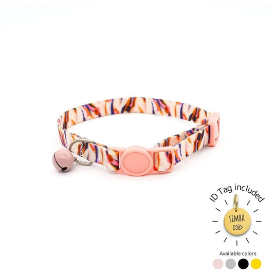 Colorful cat collar with a pink buckle and abstract orange, purple, and white design, featuring a pink bell. Includes custom ID tag.