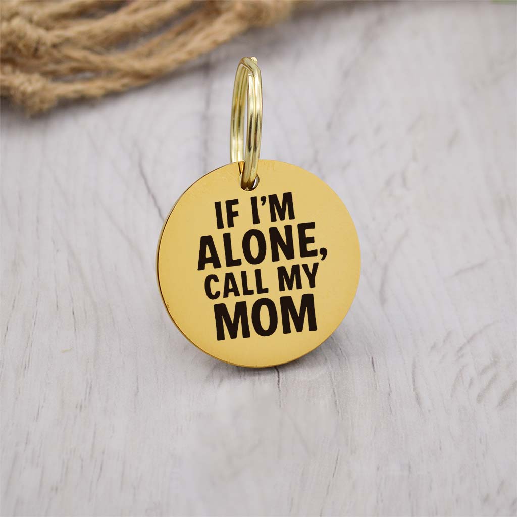 Funny gold pet ID tag with 'If I'm alone, call my mom' engraved — personalized dog or cat tag for pet safety and identification.