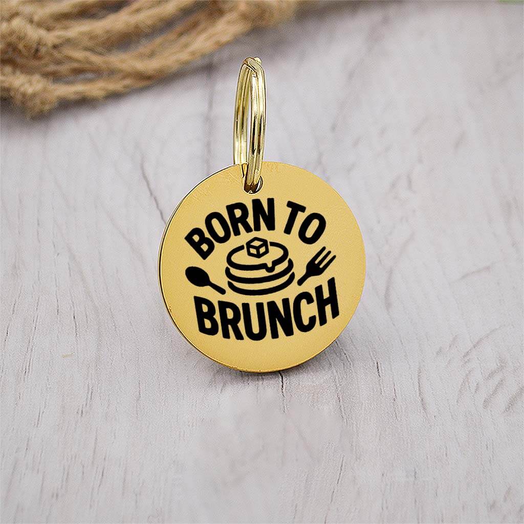 Funny gold pet ID tag with 'Born to brunch' engraved — personalized dog or cat tag for pet safety and identification.