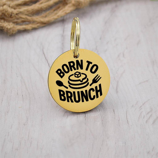 Funny gold pet ID tag with 'Born to brunch' engraved — personalized dog or cat tag for pet safety and identification.