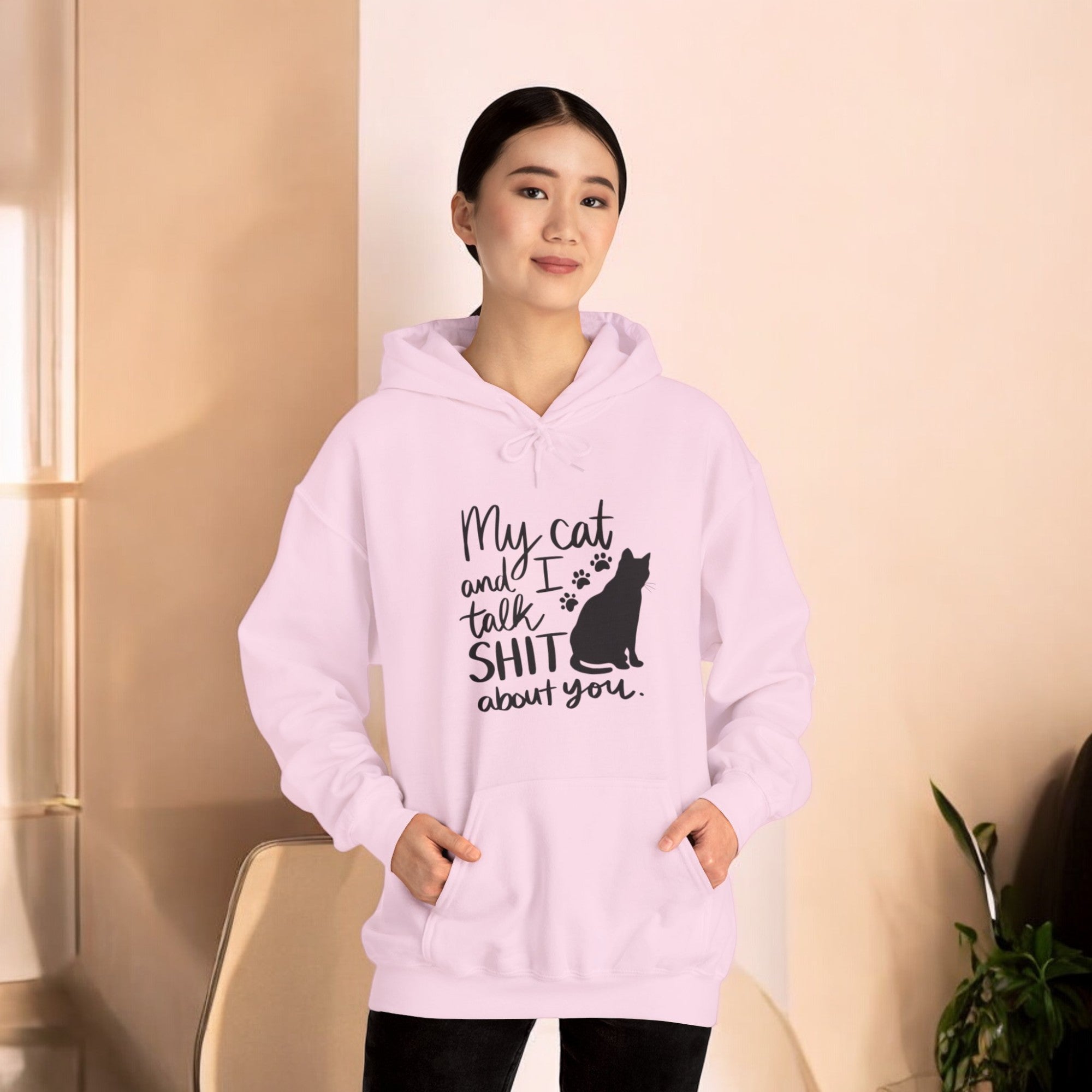 Woman wearing pink cat hoodie with text "my cat and I talk shit about you"