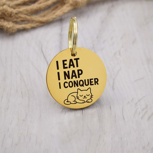 Funny gold pet ID tag with 'I eat I nap I conquer' engraved — personalized dog or cat tag for pet safety and identification