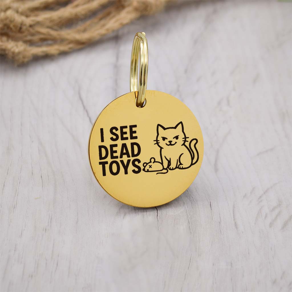 Funny gold pet ID tag with 'I See D3ad Toys' engraved — personalized dog or cat tag for pet safety and identification.