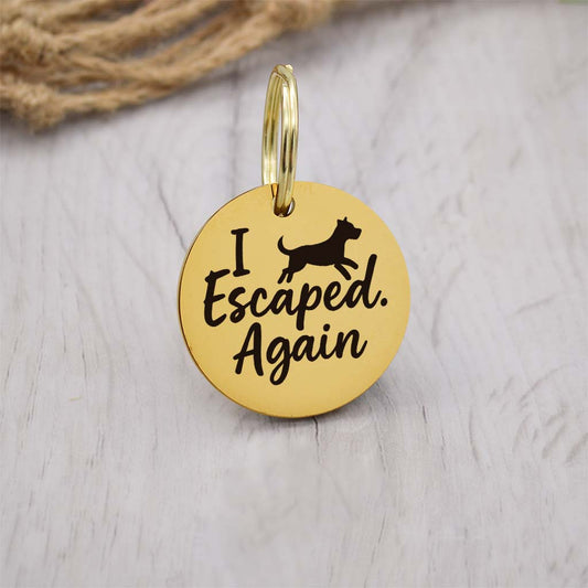 Funny gold pet ID tag with 'I Escaped.Again' engraved — personalized dog or cat tag for pet safety and identification.