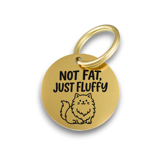 Funny gold pet ID tag for dogs and cats with the engraved text 'Not Fat, Just Fluffy' - Tag4MyPet