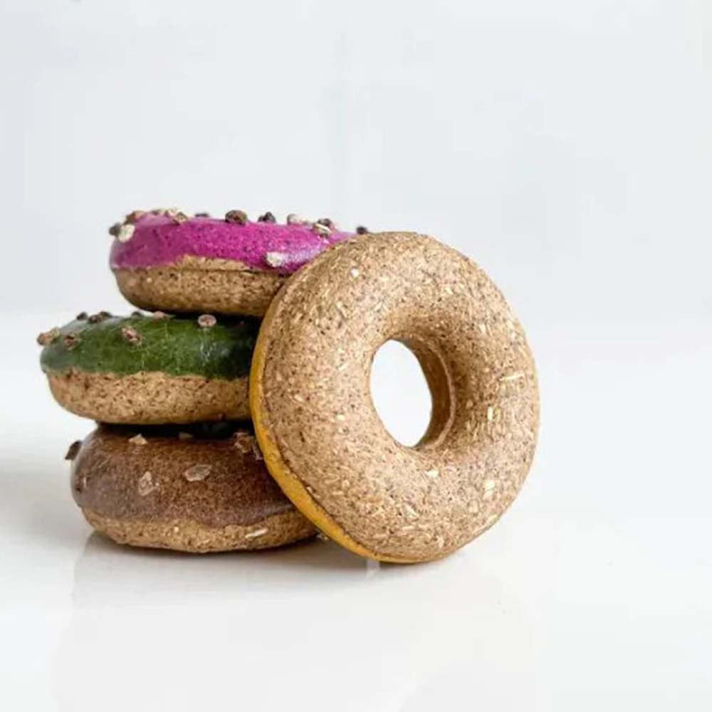 Four donut-shaped cat toys in pumpkin, pitaya, catnip, and silvervine gall fruit flavors lined up.