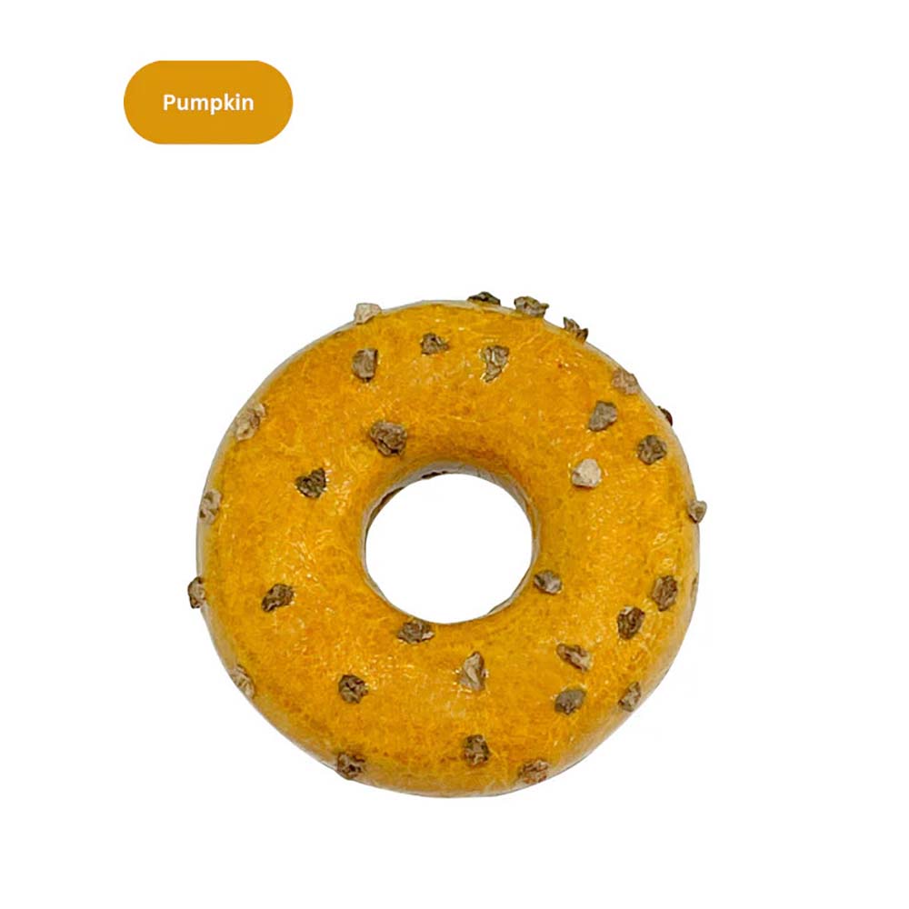 Pumpkin-flavored donut-shaped cat toy with small textured bits on top.