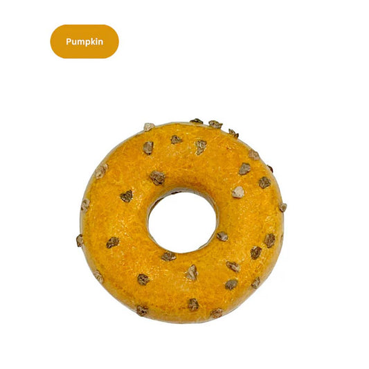 Pumpkin-flavored donut-shaped cat toy with small textured bits on top.