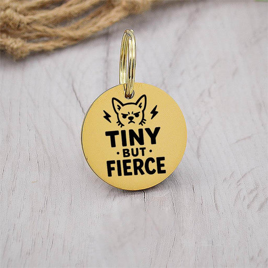 Funny gold pet ID tag with 'Tiny but fierce' engraved — personalized dog or cat tag for pet safety and identification.