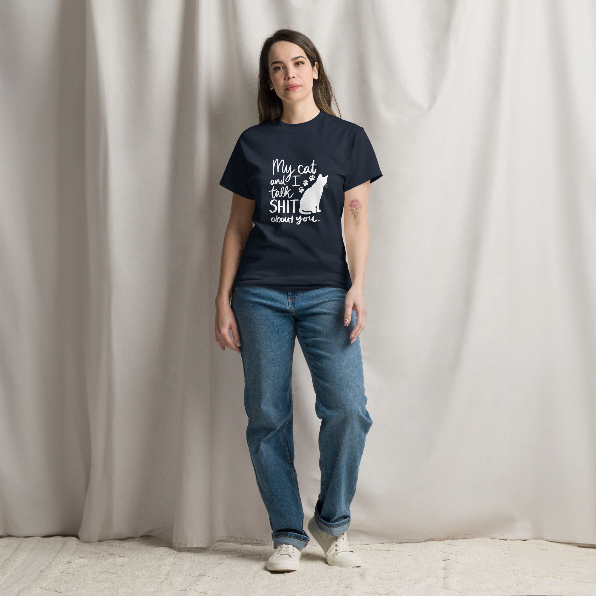 A woman wearing a navy blue t-shirt with text "My cat and I talk shit about you" with silhouette of cat and paw prints