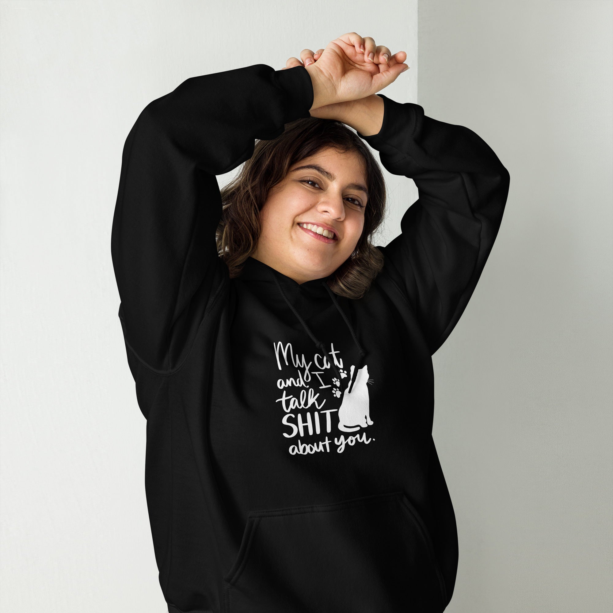 Lady wearing a black hoodie with text "My cat and I talk shit about you" with silhouette of cat and paw prints