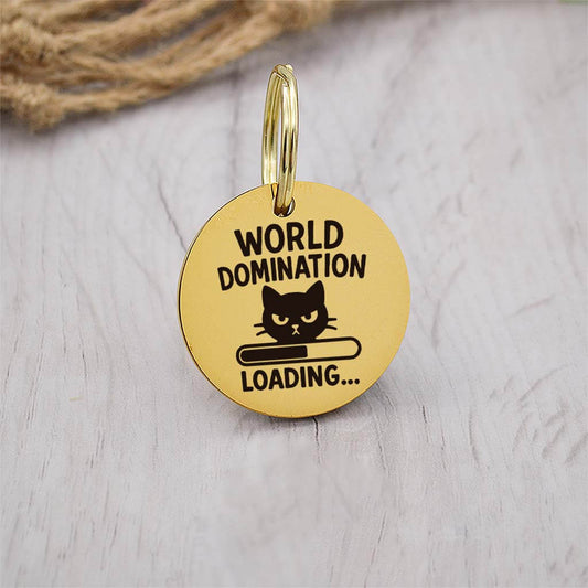 Funny gold pet ID tag with 'World Domination' engraved — personalized dog or cat tag for pet safety and identification.